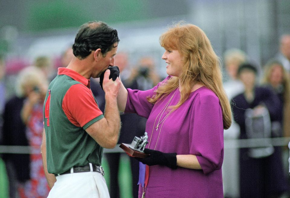 King Charles and Sarah Ferguson were always close.  Here the then Prince of Wales kisses the Duchess of York's as she presents him with a prize after a polo match in Windsor in Berkshire in 1988.