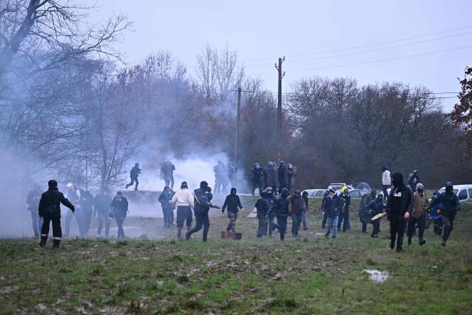 Demonstrators confront gendarmes in a cloud of tear gas, in a field near the ZAD de la Crém'arbre camp, during a demonstration against the A69 motorway project between Toulouse and Castres, in Saïx, February 10 2024. 