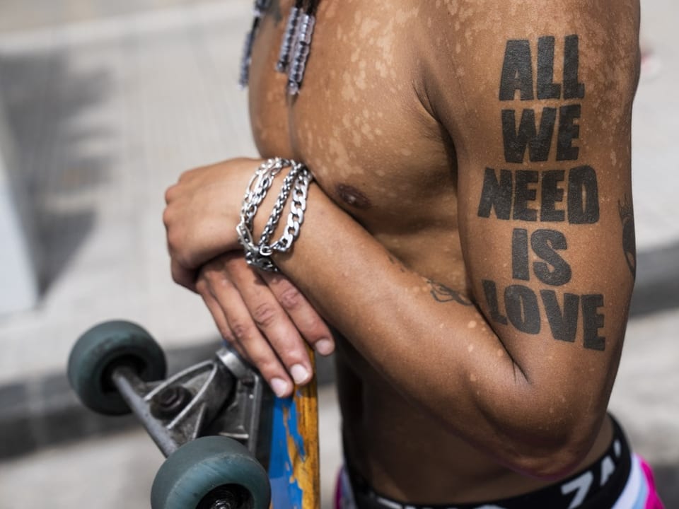 Man with a tattoo: All we need is love.