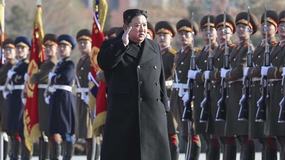 Dictator Kim Jong Un walks alongside the military. 