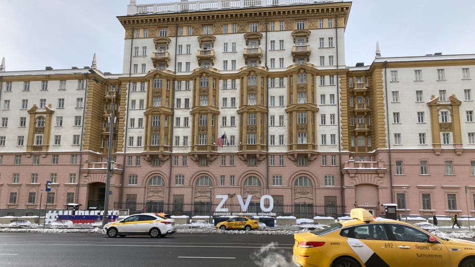 large, white and pink building, with a multi-lane road in front of it.  White letters in front of the building: “ZVO”.