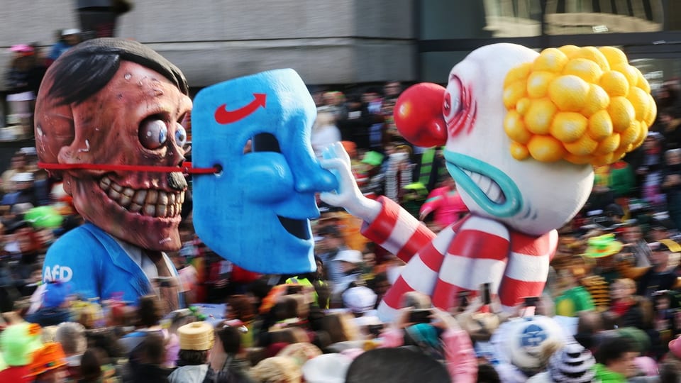 A clown pulls the mask off a skull. 