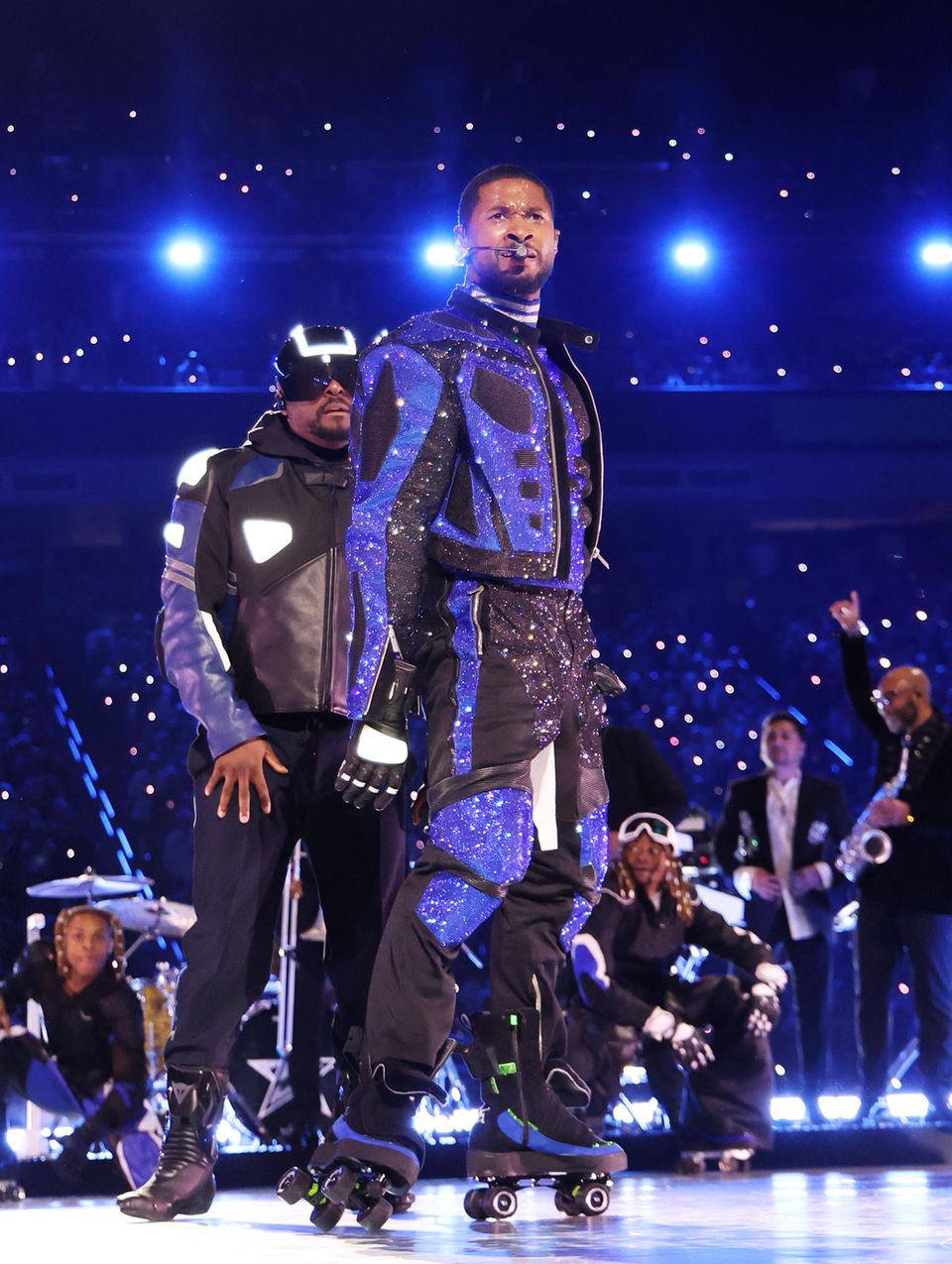 Usher switches to a completely different look.  It can be black and blue – but not without glitter.