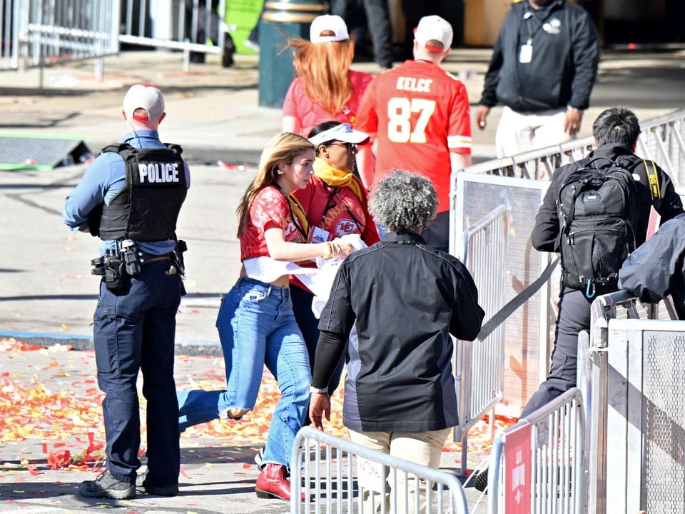 In Kansas City, people try to get through the barriers on the street where the parade was taking place.