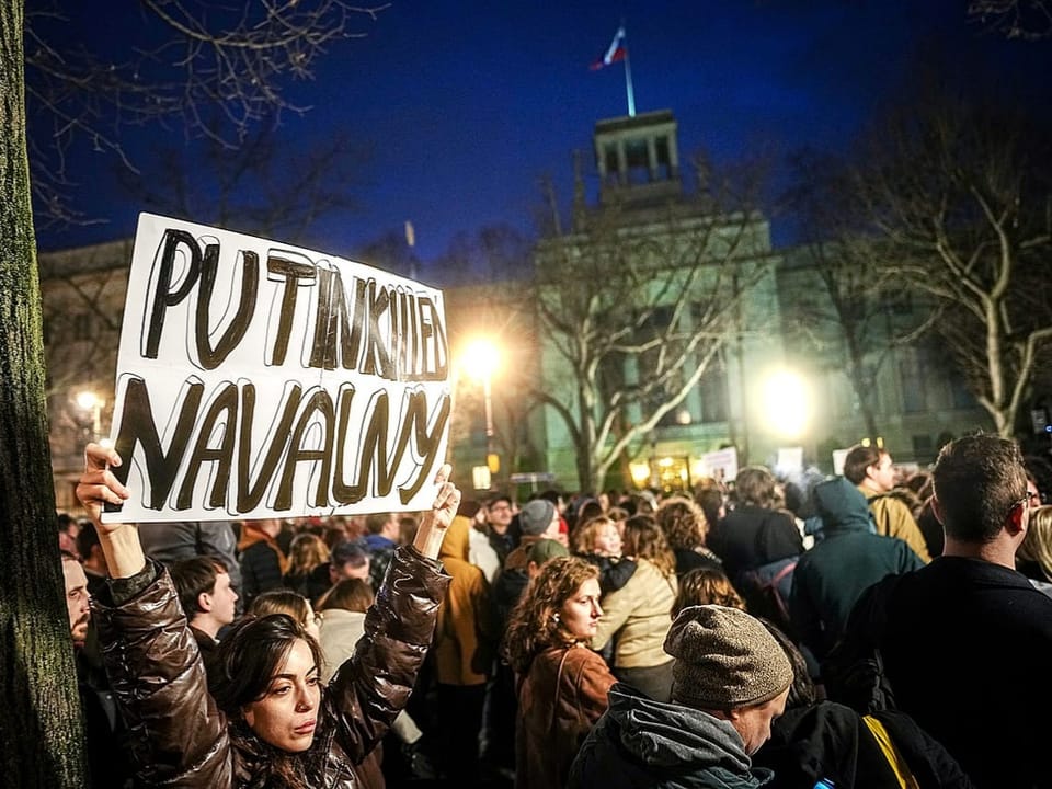Demonstrators gather with signs in front of the Russian embassy in Berlin after the death of Alexei Navalny.