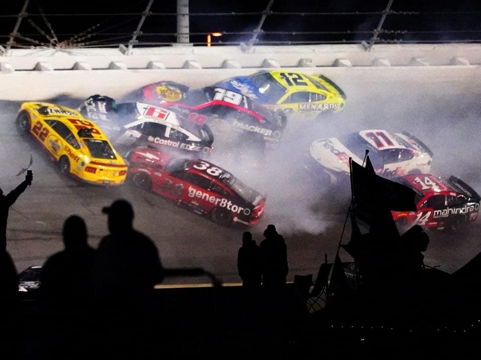 Several racing cars collide on the race track.