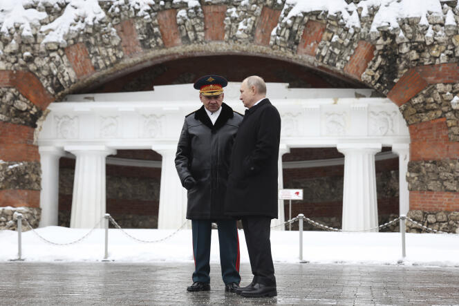 Russian Defense Minister Sergei Shoigu and President Vladimir Putin talk after a ceremony at the tomb of the Unknown Soldier in Alexander Garden on Defender of the Fatherland Day in Moscow, Friday, February 23 2024. 