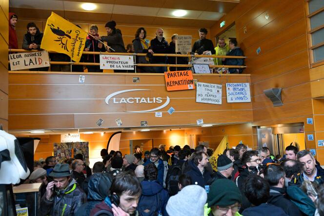 Members of the Confédération paysanne agricultural union with banners and flags during a demonstration inside the Lactalis headquarters, in Laval, on February 21, 2024. 