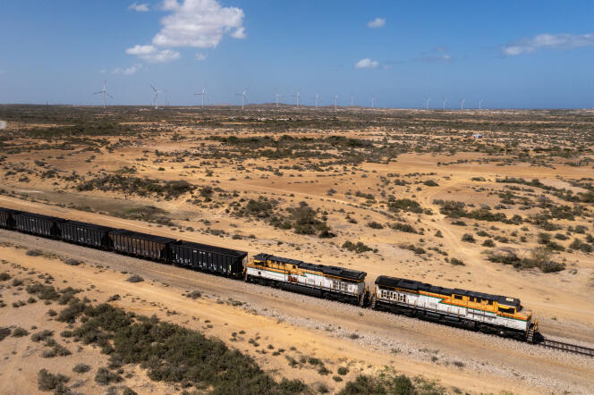 The Cerrejon mine train that transports coal ore to the Puerto Bolivar terminal in front of the Guajira 1 wind farm, at Cape de la Vela, in the Guajira region (Colombia), January 6, 2024.