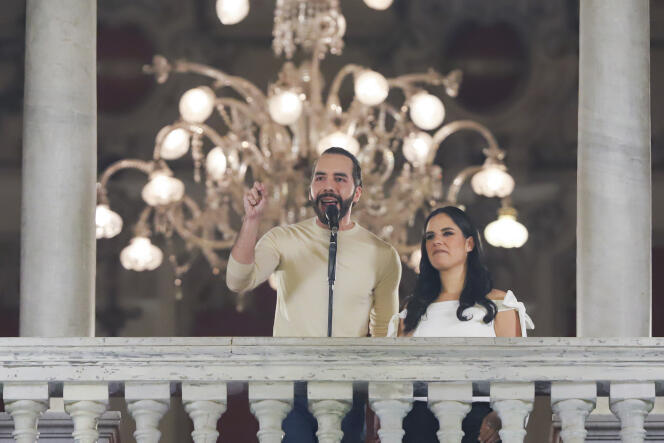 Salvadoran President Nayib Bukele, accompanied by his wife, Gabriela Rodriguez, addresses his supporters from the balcony of the presidential palace in San Salvador, after his re-election for a new five-year term, Sunday February 4, 2024.