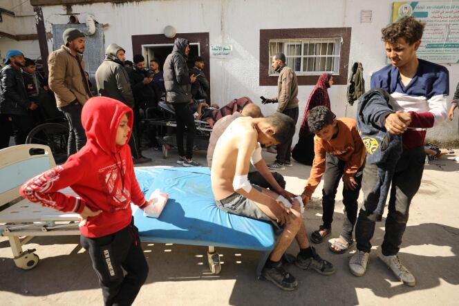 Palestinians receive medical treatment at Kamal Edwan Hospital in Beit Lahya, northern Gaza Strip, on February 29, 2024, after shooting at Gazans waiting for trucks loaded with humanitarian aid.