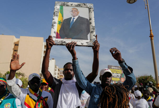 Supporters of President Macky Sall march to support him after the postponement of the presidential election, in Dakar, February 24, 2024.