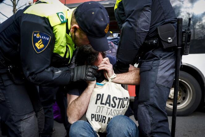 Dutch police arrest a climate protester while blocking the Utrechtsebaan section of the A12 in the center of The Hague, February 3, 2024. 