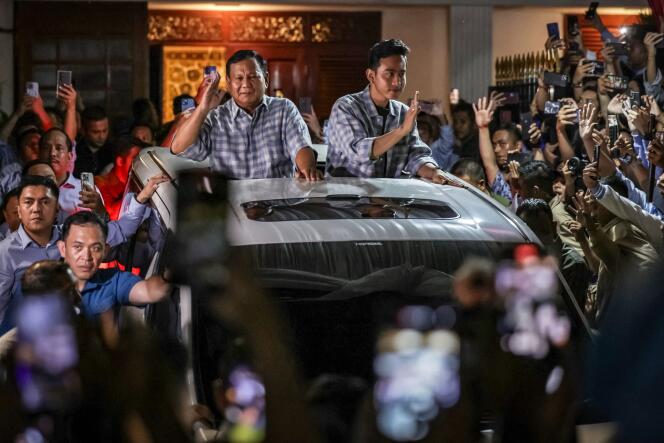 Prabowo Subianto (left) and vice-presidential candidate Gibran Rakabuming Raka (right), son of outgoing Indonesian President Joko Widodo and current mayor of the city of Surakarta, cheered by supporters as they leave the residence of Prabowo Subianto, Wednesday February 14.