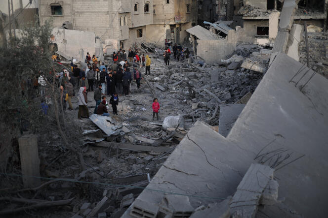 Palestinians on the ruins of a house after an Israeli strike in Rafah, in the south of the Gaza Strip, February 12, 2024.