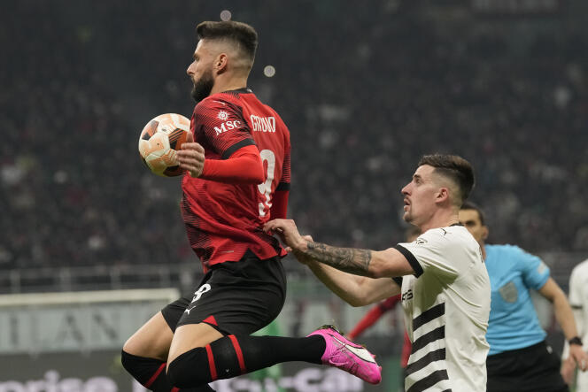 Olivier Giroud intercepts a ball for AC Milan during a duel with Rennais Baptiste Santamaria in the Europa League, in Milan, February 15, 2024.