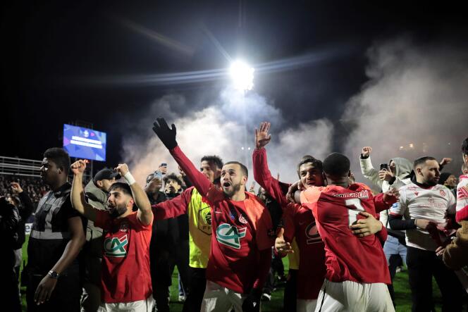 Rouen players celebrate their victory in the round of 16 of the Coupe de France against AS Monaco at the Robert-Diochon stadium in Petit-Quevilly (Seine-Maritime), February 8, 2024.