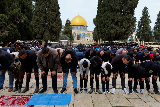 Palestinians pray outside the Al-Aqsa mosque on February 23, 2024. 