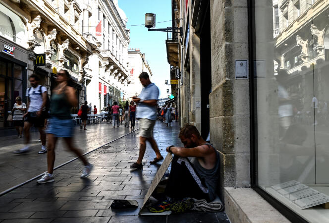 A homeless person begs in a street in Bordeaux, August 24, 2023.