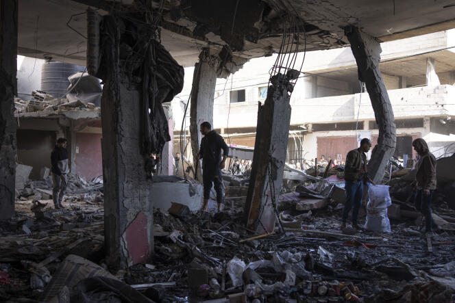 Palestinians in the ruins of a building damaged by an Israeli bombing in Rafah, February 24, 2024.