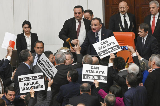 Turkish parliamentarians hold signs reading “Freedom for Can Atalay” in Ankara on January 30, 2024.