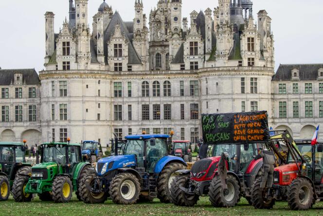 Tractors carrying banners “No country without peasants” and “Agriculture, small we dream, big we die” are parked in front of the castle of Chambord, in eastern France, on February 15, 2024.