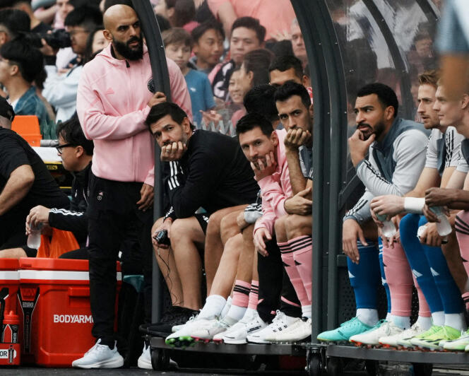 Lionel Messi (seated center with pink tracksuit top) during an Inter Miami match on February 4, 2024, in Hong Kong.