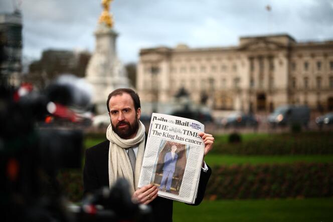 A journalist with a copy of “The Times” in hand, outside Buckingham Palace, Tuesday February 6, 2024.