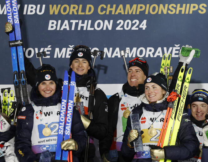 Julia Simon, Eric Perrot, Quentin Fillon Maillet and Justine Braisaz-Bouchet (from left to right) celebrate their title as mixed relay world champions, in Nove Mesto, Czech Republic, February 7, 2024. 