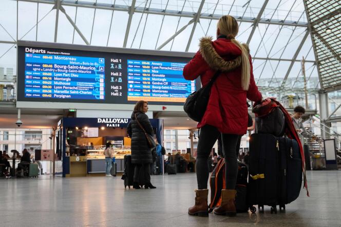 A passenger examines the departures display board, Gare de Lyon in Paris on February 16, 2024, during the SNCF controllers' strike.