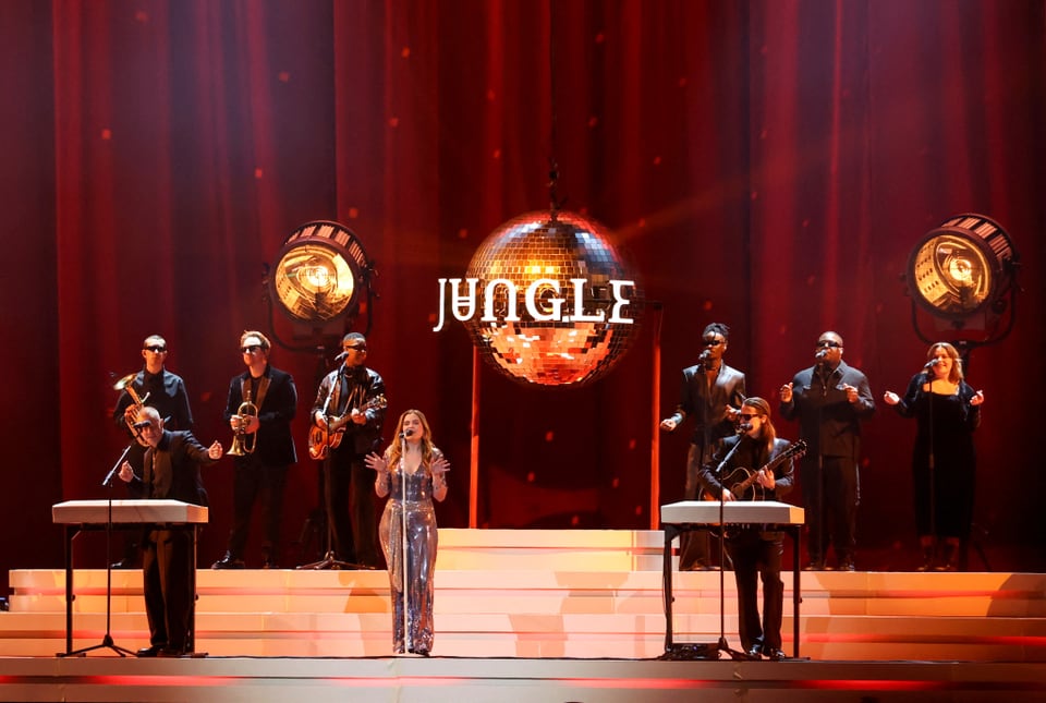 The band Jungle can be seen on stage.  There are eight members visible.