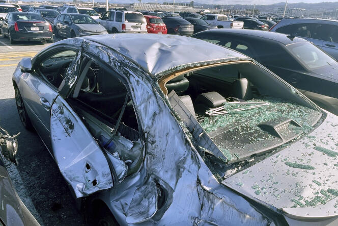 A damaged car in a parking lot at San Francisco airport, after a wheel fell off a plane, March 7, 2024.