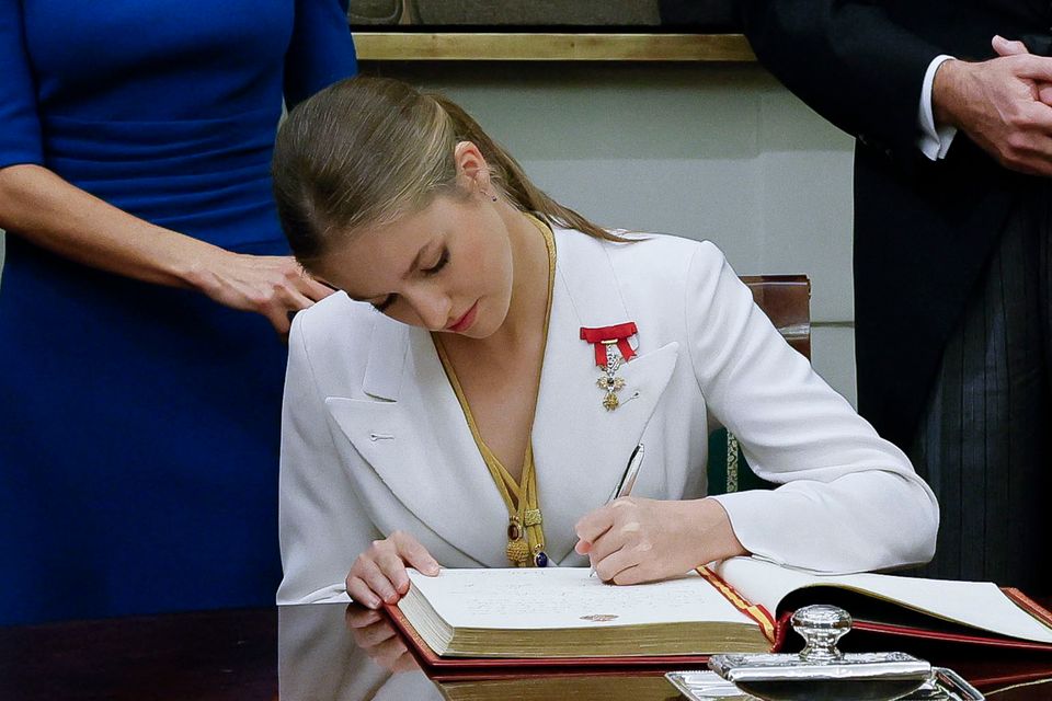 Princess Leonor, left, signs the Book of Honor of the Congress during a ceremony to swear in loyalty to the Constitution on her 18th birthday at the House of Representatives in Madrid on October 31, 2023.