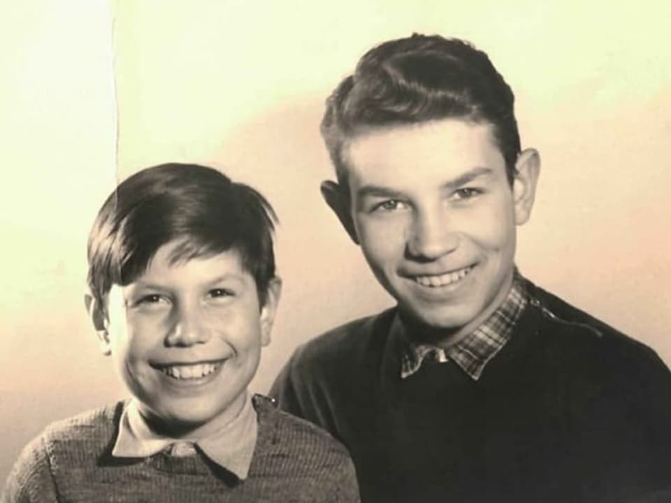 Two boys laugh into the camera.