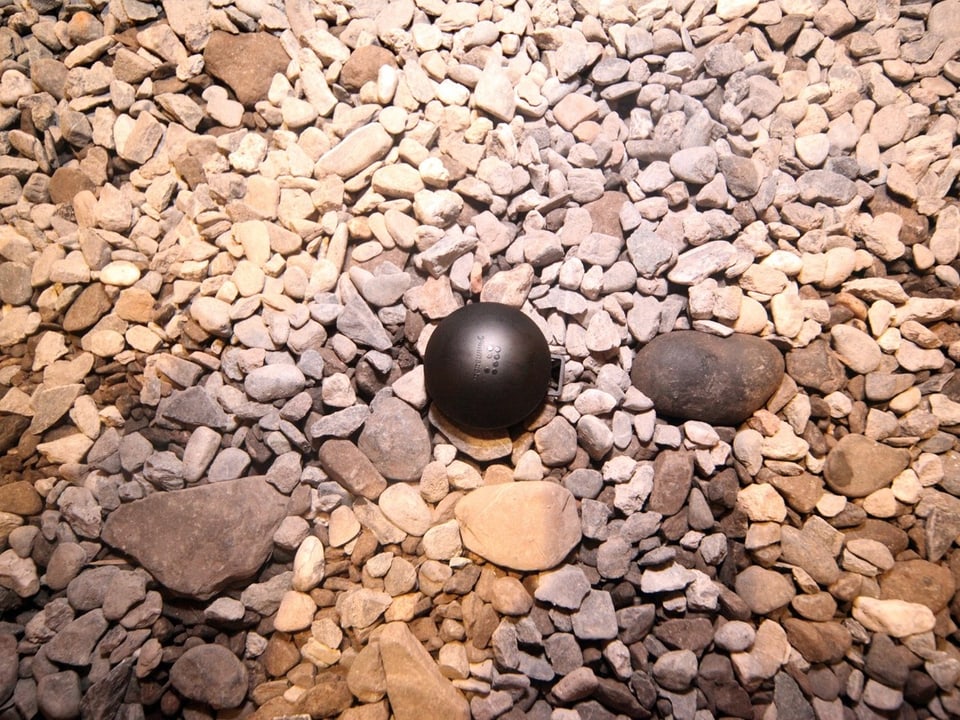 A measuring device on a stone floor.
