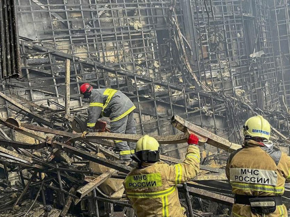Firefighters remove burned debris