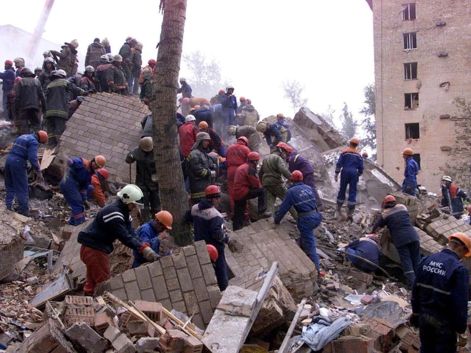 Rescue workers search through rubble