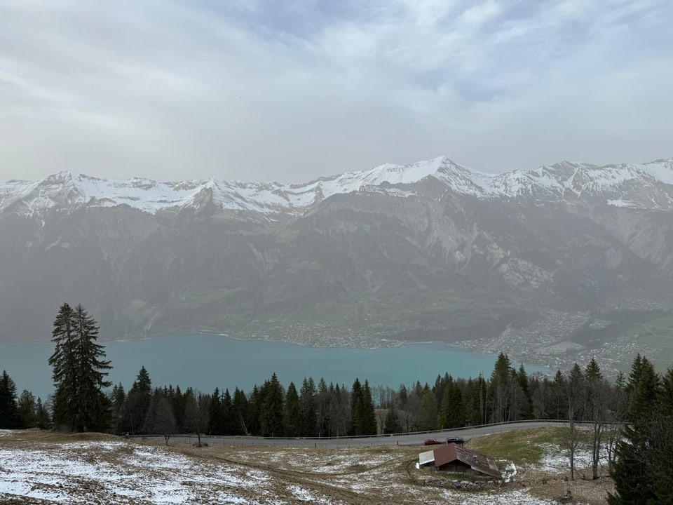 Blurred view of Lake Thun and mountains due to Sahara dust.