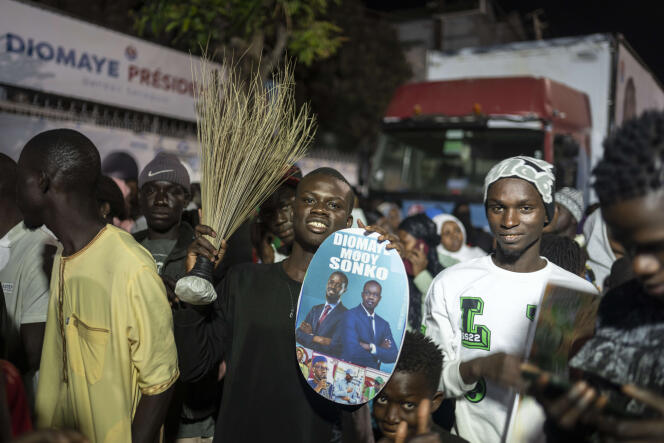 Supporters of presidential candidate Bassirou Diomaye Faye and Senegal's main opposition leader Ousmane Sonko gather outside their campaign headquarters as they await the results of the presidential election, in Dakar, March 24, 2024 .
