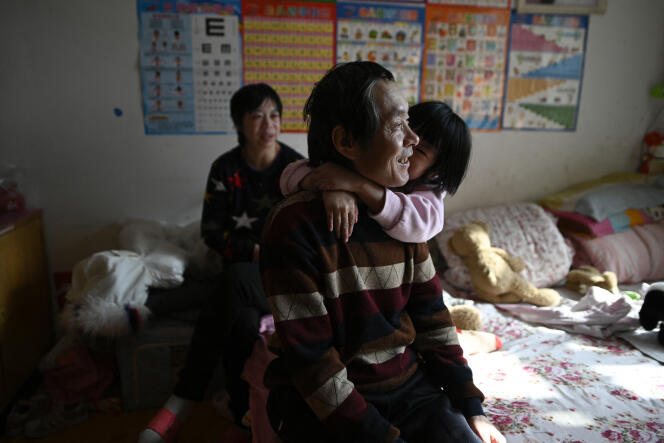 A migrant worker working in the capital, with his daughter in their apartment in Beijing, 2021. Migrant workers face the dilemma of leaving alone or with their children.