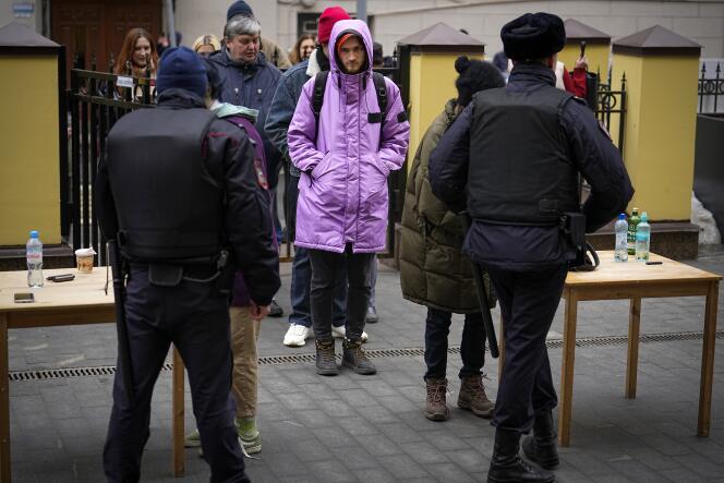 Voters queue outside a polling station in Moscow, Russia, Sunday March 17, 2024.