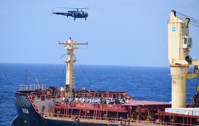 This photo shared by the Indian Navy on X on March 16, 2024 shows people on board the Maltese ship MV Ruen, as an Indian Navy helicopter flies overhead.