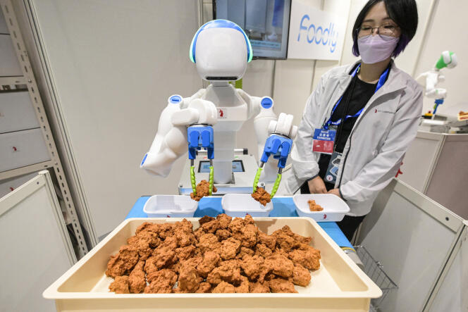 A robot sorts and places pieces of fried chicken into boxes during the International Robot Exhibition at the Tokyo International Exhibition Center, Japan, on November 29, 2023.