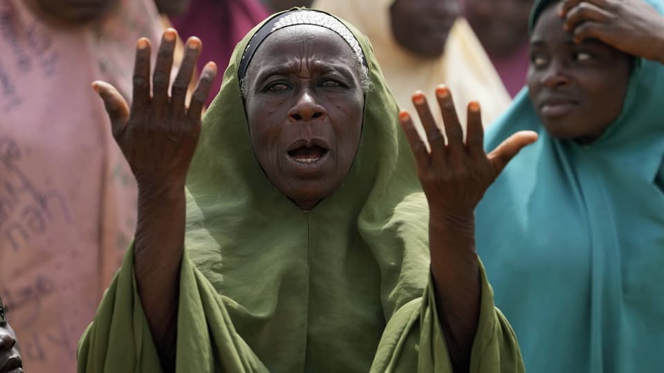 Woman prays for the kidnapped children from her village.