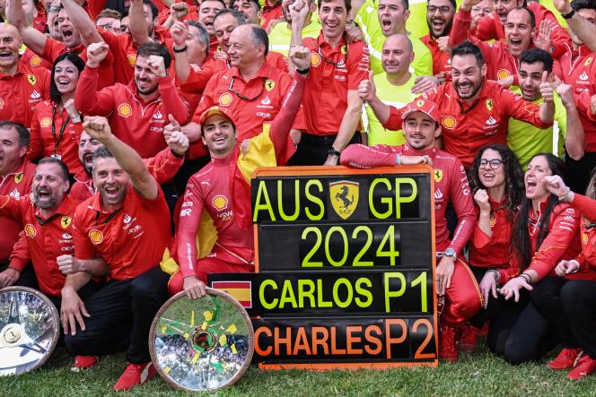 The joy of Scuderia Ferrari after the victory of Carlos Sainz (center, left) in front of his teammate driver Charles Leclerc (to his right) in Melbourne, March 24, 2024.
