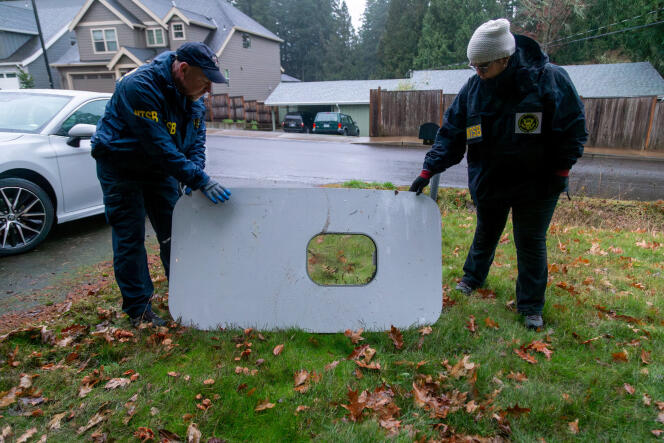 National Transportation Safety Board investigators examine the door cap of the Alaska Airlines Boeing 737-9 MAX, at the property where it was recovered, in Portland, Oregon, United States, January 8, 2024.