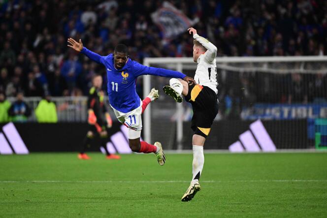 French striker Ousmane Dembélé and German defender Maximilian Mittelstädt during the friendly football match between France and Germany, at the Groupama stadium in Décines-Charpieu, (Rhône), March 23, 2024.