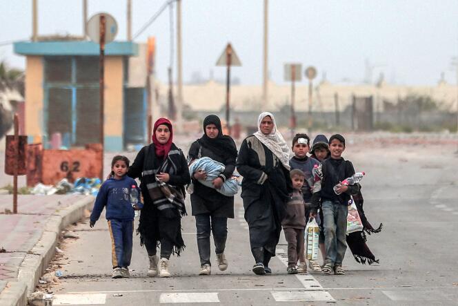 Displaced Palestinians who fled the area around Al-Shifa Hospital in Gaza City arrive at the Nusseirat refugee camp in the central Gaza Strip on March 18, 2024.