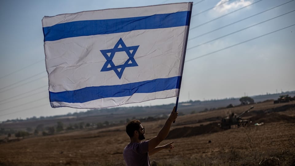 A man waves the Israeli flag.