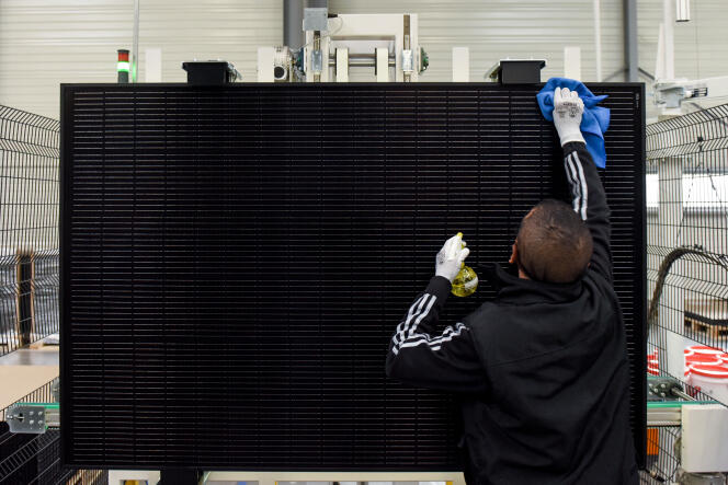 A Systovi employee cleans a solar panel on a production line at the solar energy equipment supplier's factory in Carquefou, near Nantes, March 6, 2023. 